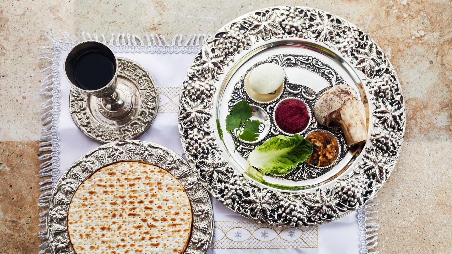 Composition with symbolic Passover, Pesach, items and meal on stone background,